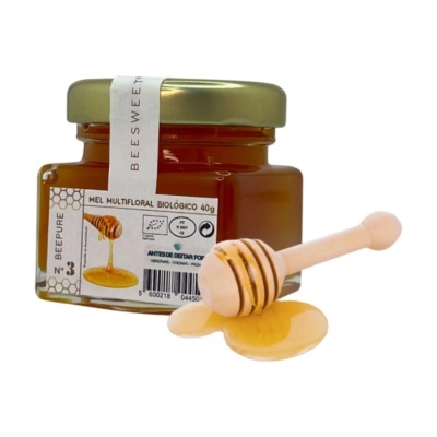 Frasco de mel multifloral biológico com colher de madeira e mel