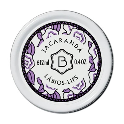 Embalagem circular branca com rótulo floral roxo e texto preto Jacarandá Bálsamo labial 12ml