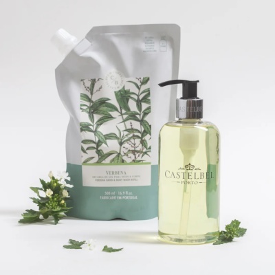 Frasco doseador de gel amarelo com embalagem de recarga branca e verde com folhas, flores e texto em português