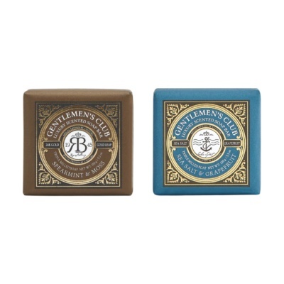 Duas barras de sabão embaladas com design elegante, uma castanha e outra azul.