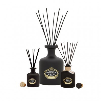 Três difusores de ambiente em vidro fosco preto com rótulos dourados e palitos pretos