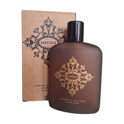 Frasco fosco castanho de after shave com embalagem castanha e padrão decorativo.