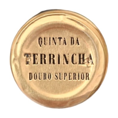 Tampa de cortiça dourada com inscrições em preto