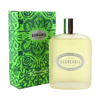Frasco fosco amarelo claro de perfume com rótulo oval e caixa verde com padrão floral