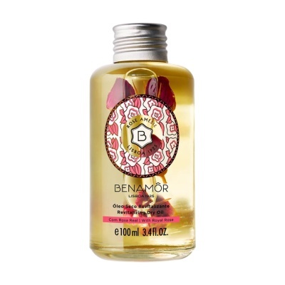 Frasco de óleo seco revitalizante com pétalas de rosa dentro e etiqueta floral
