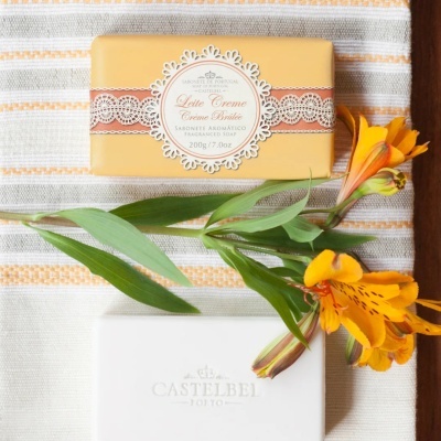 Sabonete aromático Leite Creme Creme Brûlée em embalagem amarela com flores amarelas e pano listrado