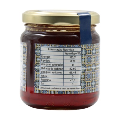 Frasco de vidro com tampa dourada e etiqueta com informação nutricional em português