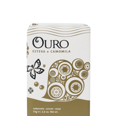Embalagem de sabonete Ouro Esteva e Camomila com design branco e dourado e desenhos circulares