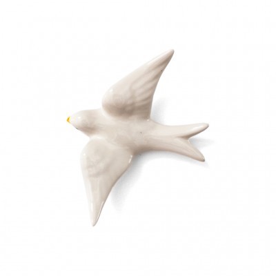 Escultura de porcelana branca em forma de andorinha