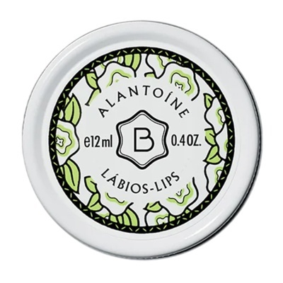 Embalagem de creme labial branca com decoração floral verde e texto ALANTOÍNE LÁBIOS-LIPS