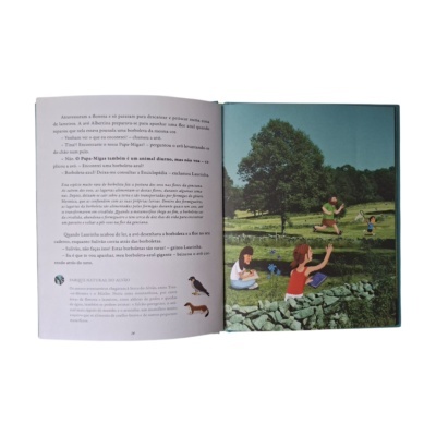 Livro aberto com texto em português e ilustração colorida de uma paisagem natural com pessoas
