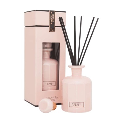 Difusor de aromas rosa pastel com varas pretas e caixa embalagem