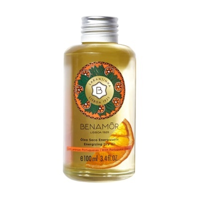 Frasco de óleo seco Benamôr com rótulo de laranjas e folhas verdes.