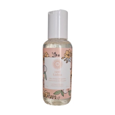 Frasco transparente de gel de duche e champô com rótulo rosa florido e tampa branca