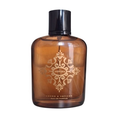 Frasco âmbar de perfume com tampa preta e decoração dourada