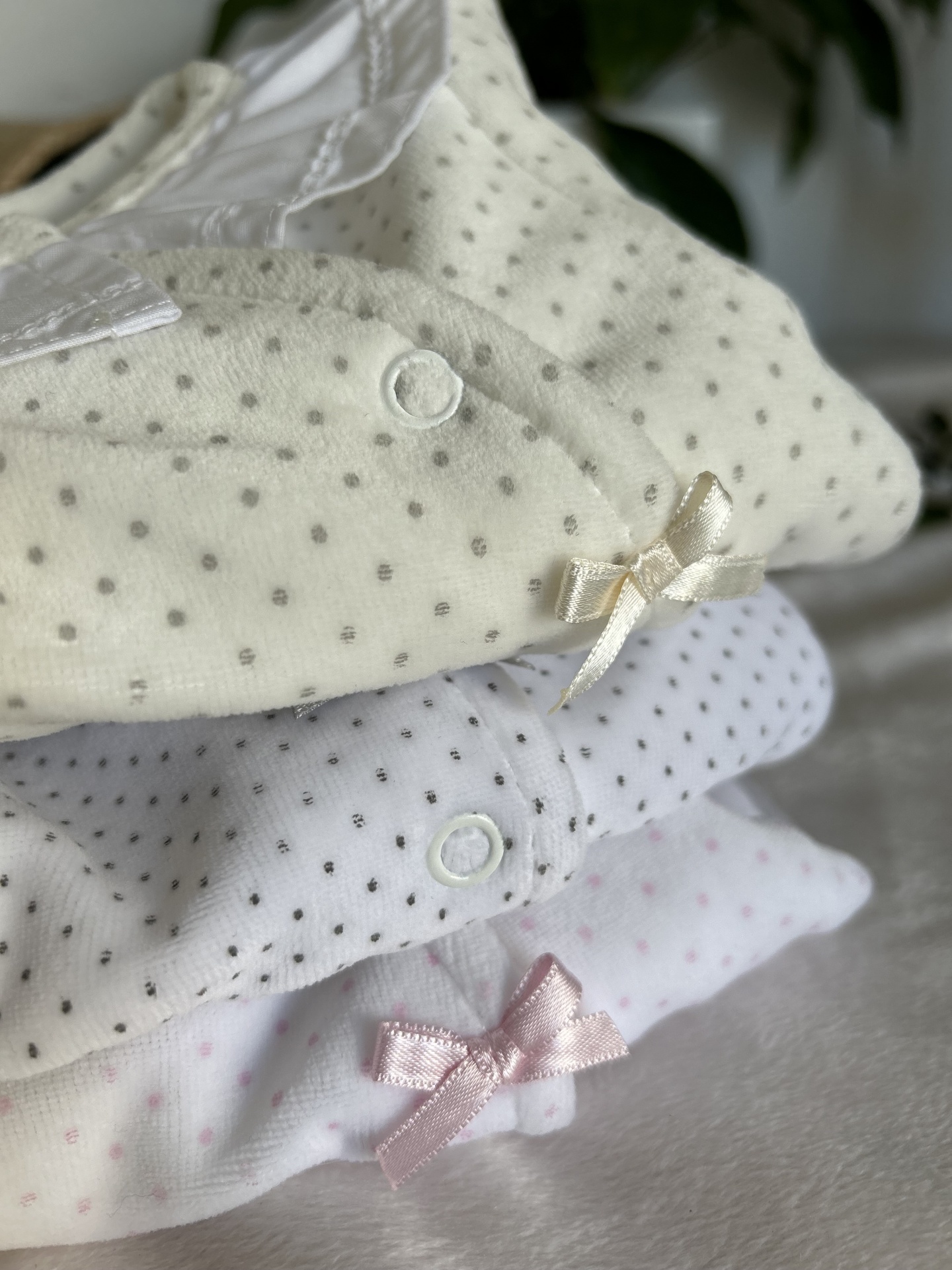 Três bodies de bebé com padrão de pontos e laços em cetim