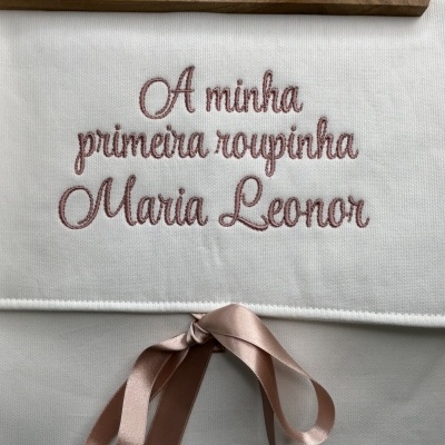 Saco branco bordado com texto cor-de-rosa e fita rosa amarrada em laço