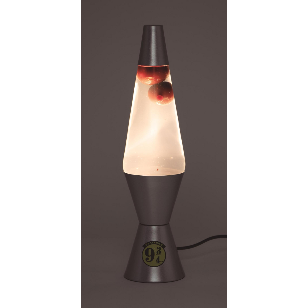 Lâmpada de lava com gotas vermelhas e base cinzenta escura com etiqueta 9 3/4