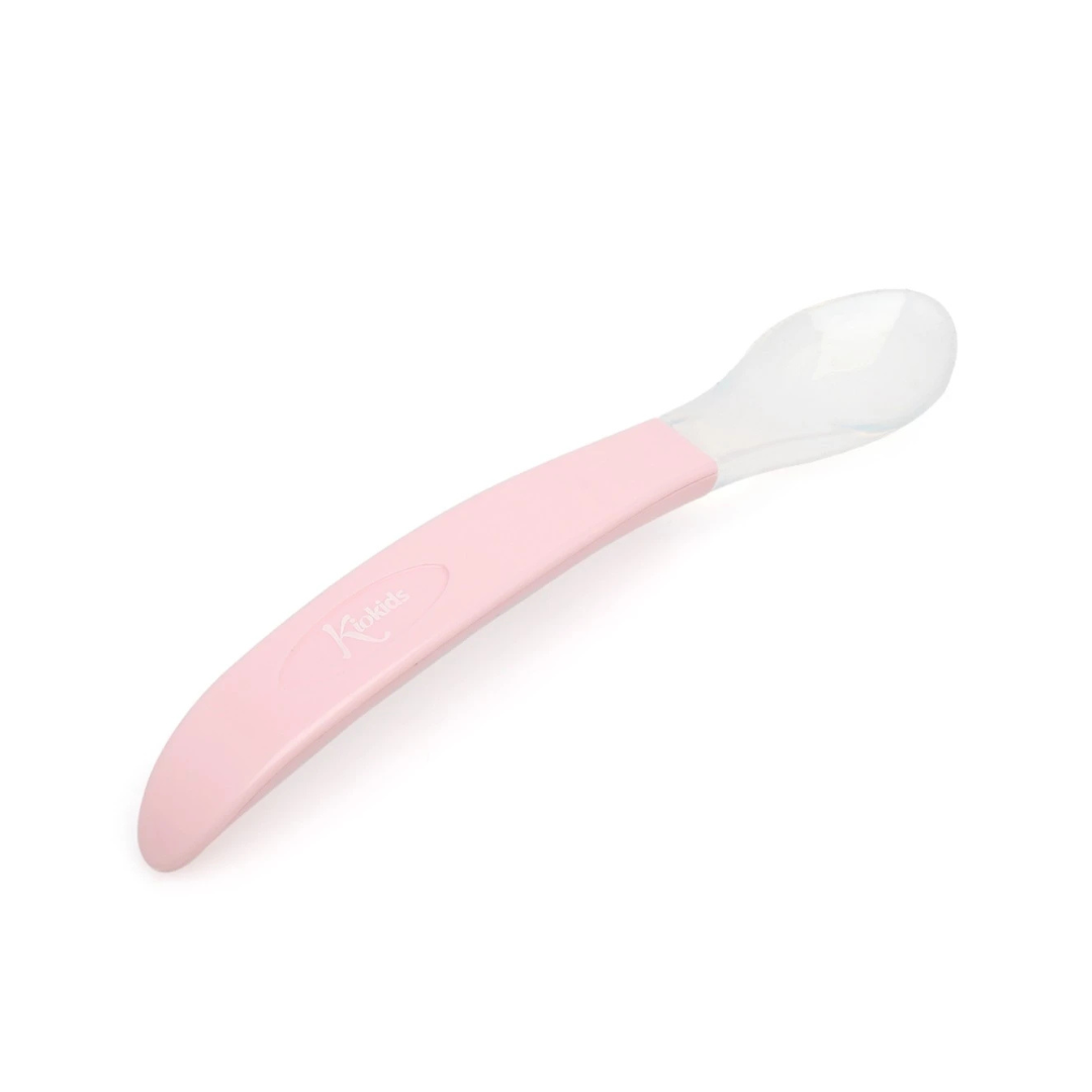 Colher para bebés com cabo rosa e parte da colher transparente