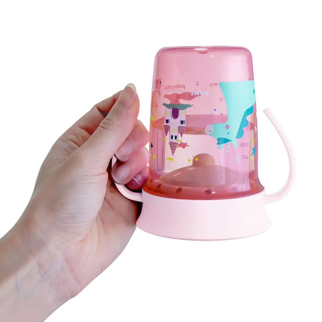 Chávena infantil rosa com tampa transparente e desenhos coloridos