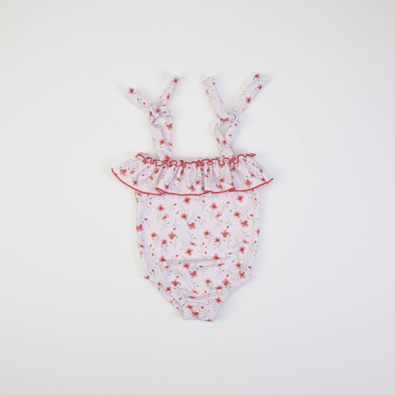 Fato-de-banho branco com flores vermelhas e folho no peito para bebé
