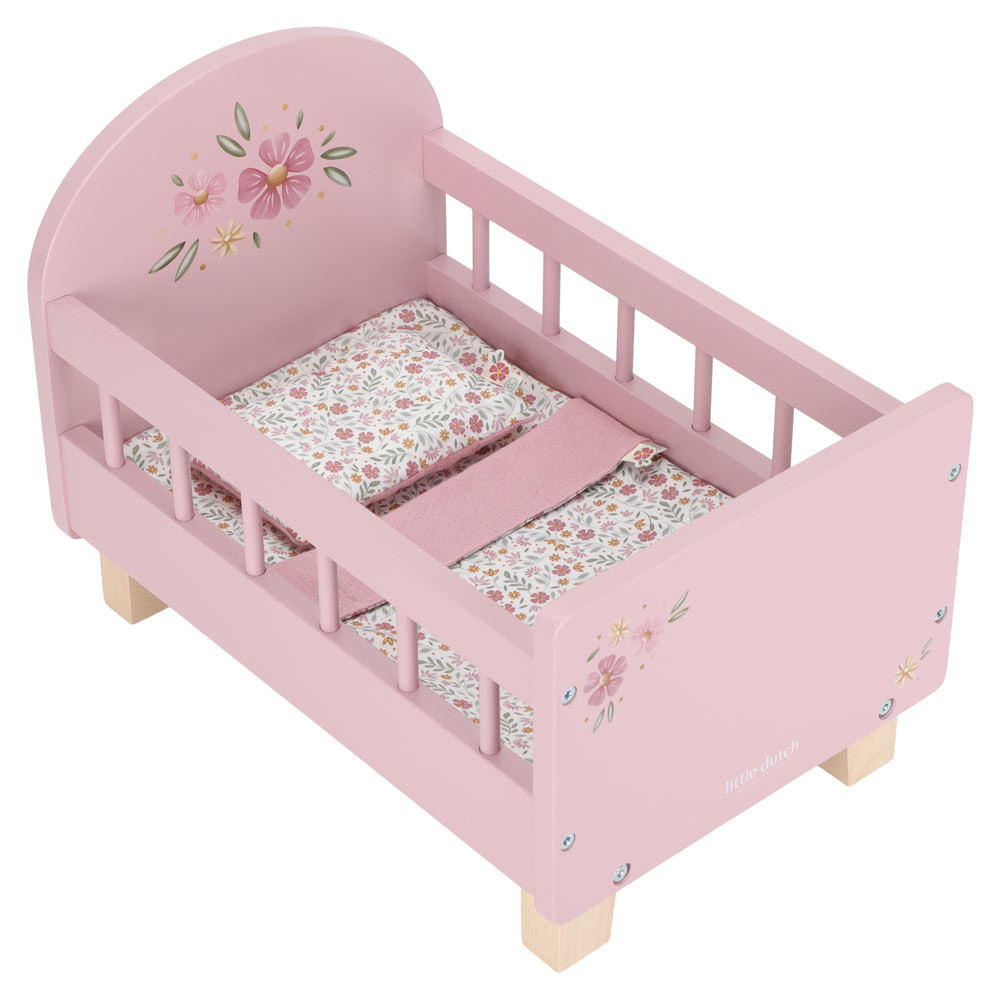 Cama de bonecas de madeira rosa com flores pintadas e roupa de cama floral