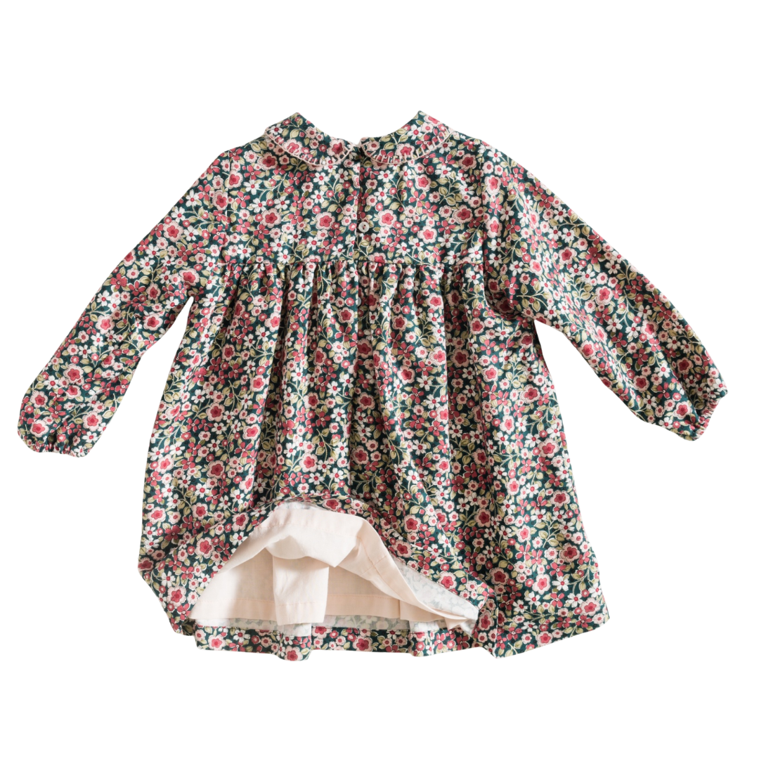 Vestido de bebé floral com gola arredondada e mangas compridas.