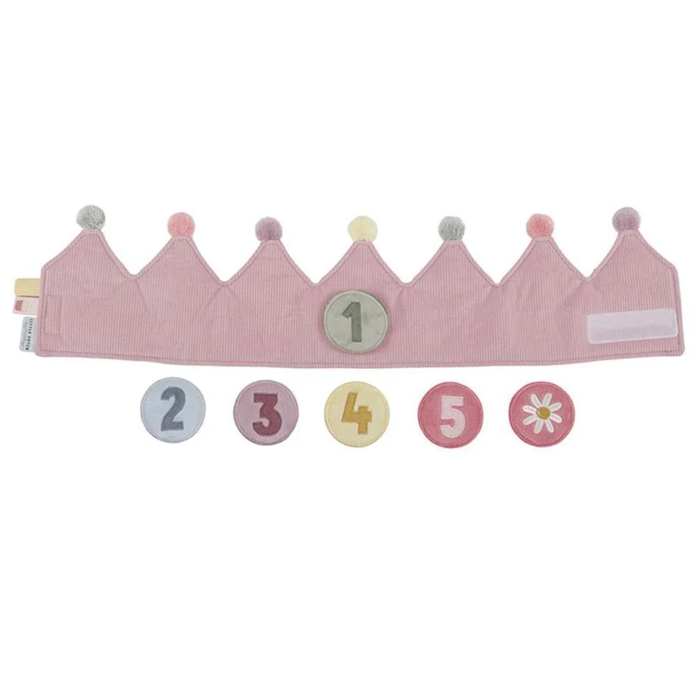 Coroa de tecido rosa com pompons e círculos numerados para idades