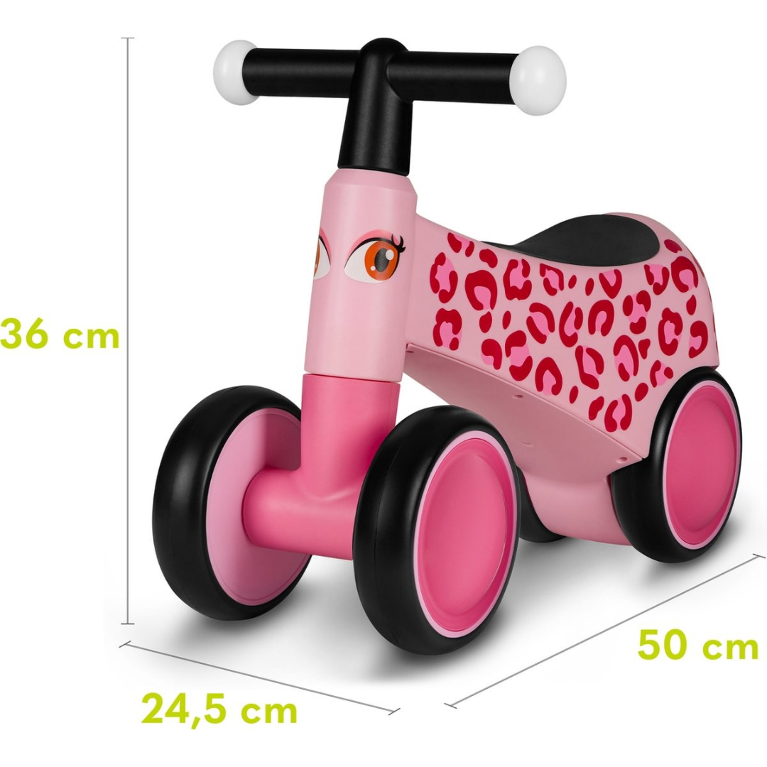 Triciclo infantil cor-de-rosa com padrão de manchas vermelhas e rodas pretas