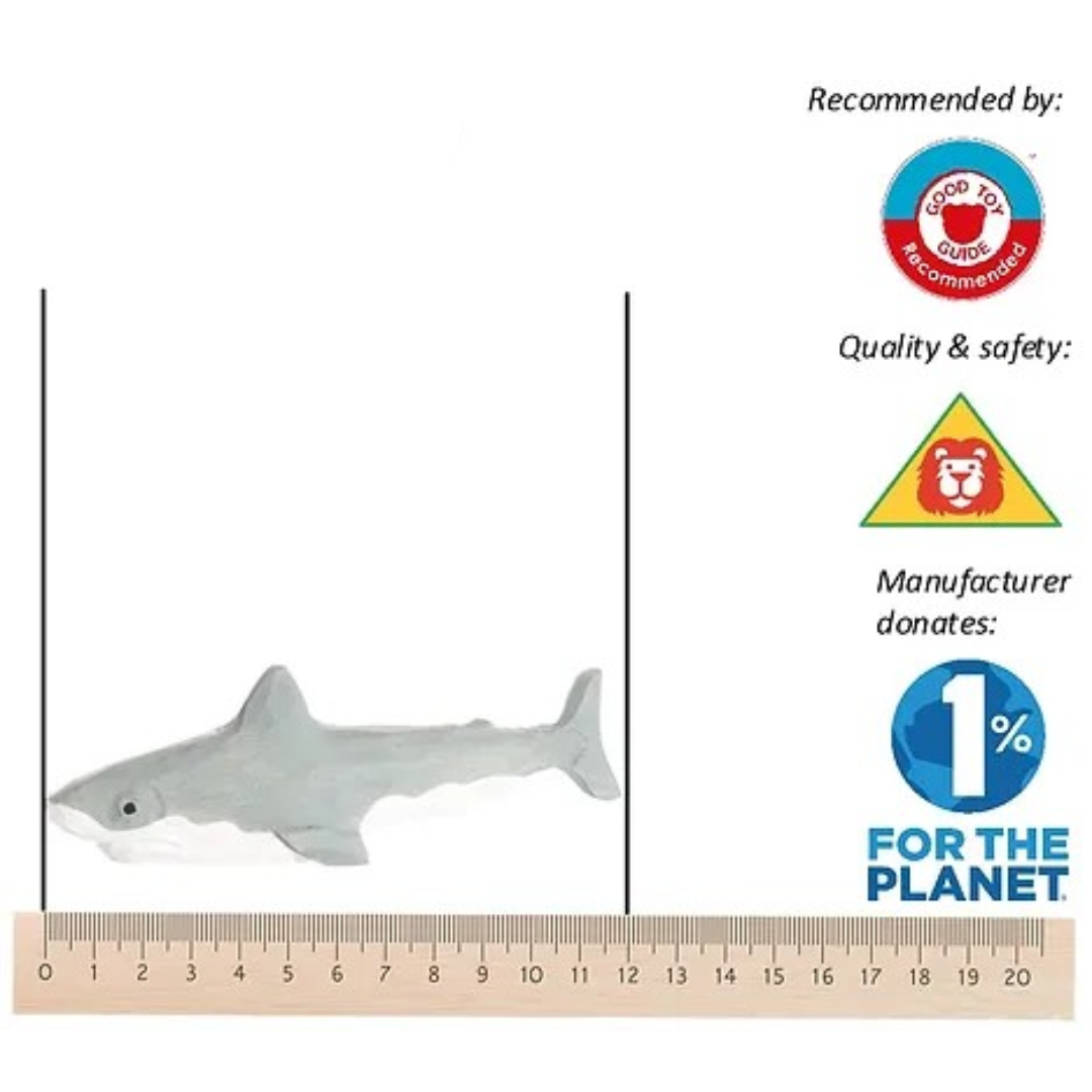 Brinquedo de tubarão cinza claro com régua e selos coloridos ao lado