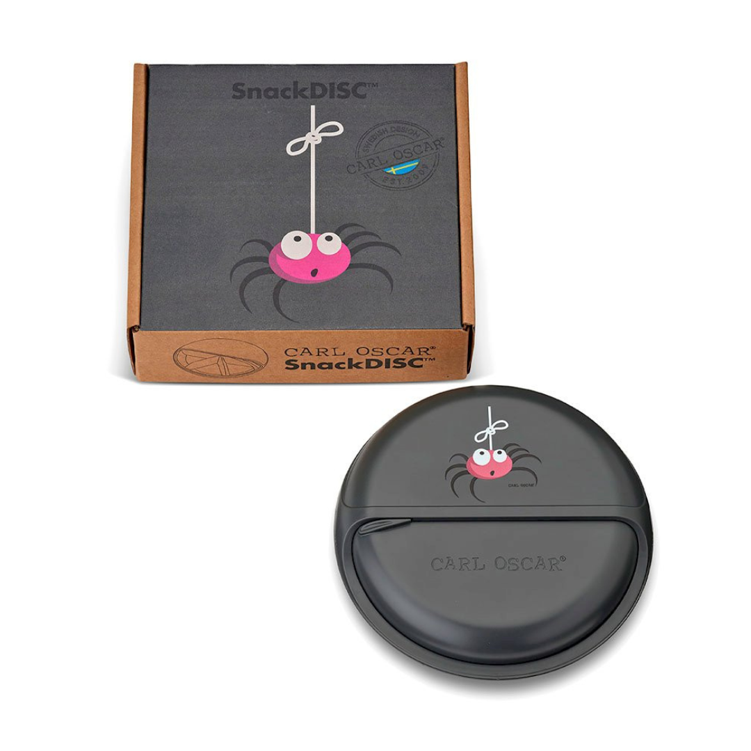 Prato redondo cinzento com aranha rosa suspensa, embalagem de cartão castanho com texto.