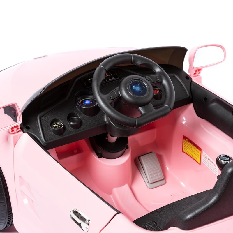Carro de brincar rosa com volante preto e pedal