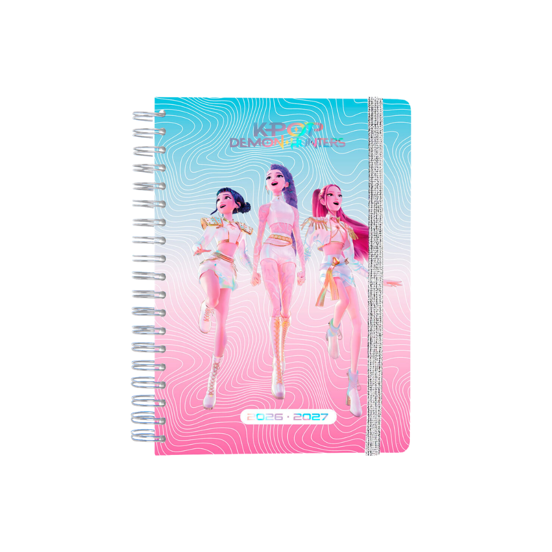 Caderno espiral colorido com personagens femininos e texto K-POP DEMON HUNTERS 2026-2027