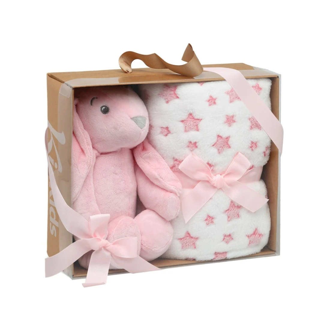 Coelho de peluche rosa com manta branca de estrelas cor-de-rosa numa caixa de presente.