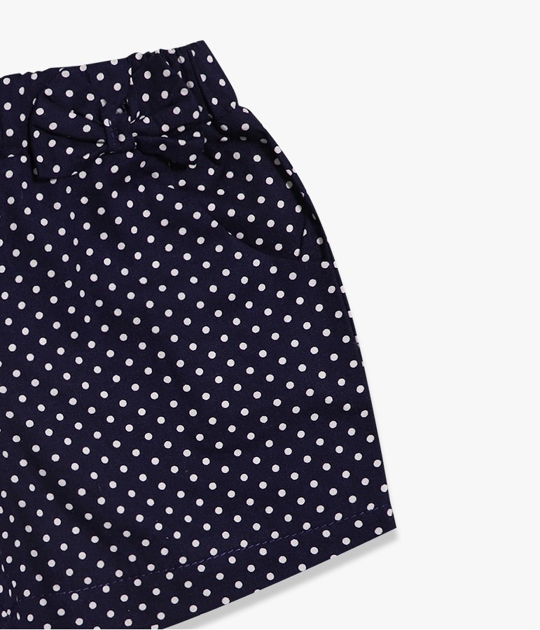 Saia azul escura com bolinhas brancas e laço