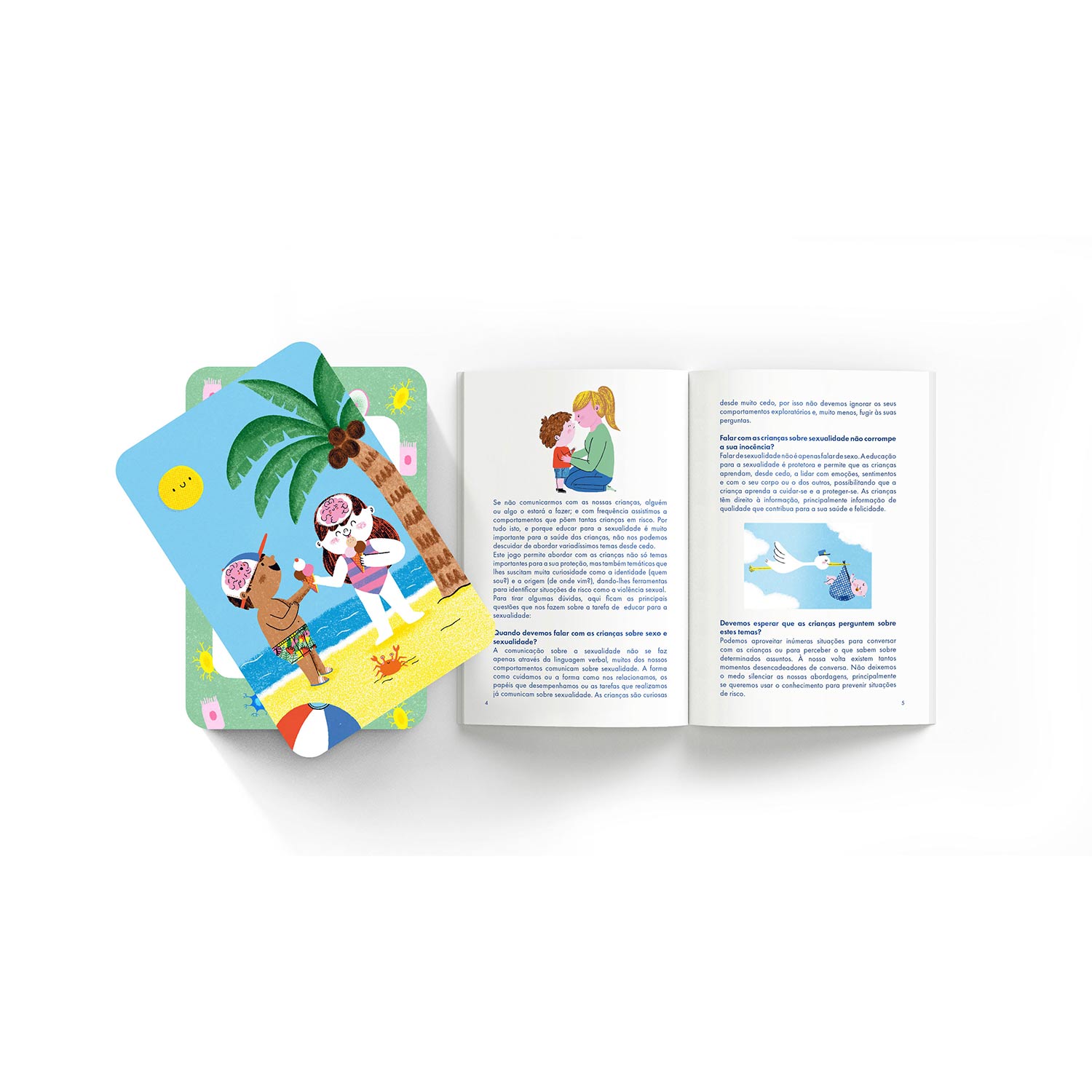 Cartas coloridas com ilustração de praia ao lado de um livro aberto com texto em português e ilustrações de uma mãe com uma criança e uma cegonha.