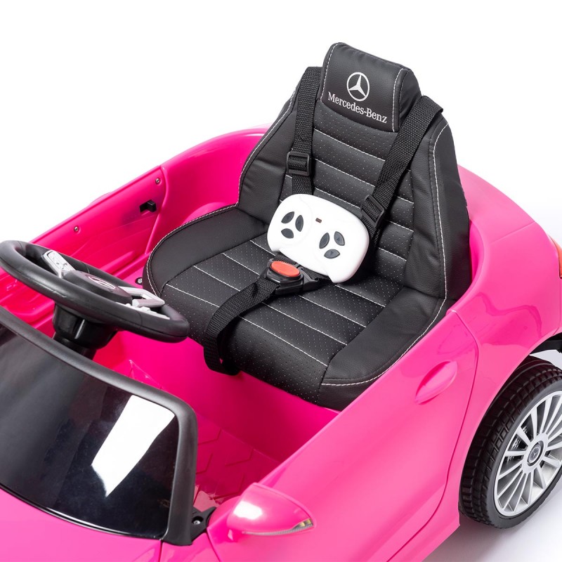Carro elétrico cor-de-rosa para crianças com banco preto e volante e cinto de segurança