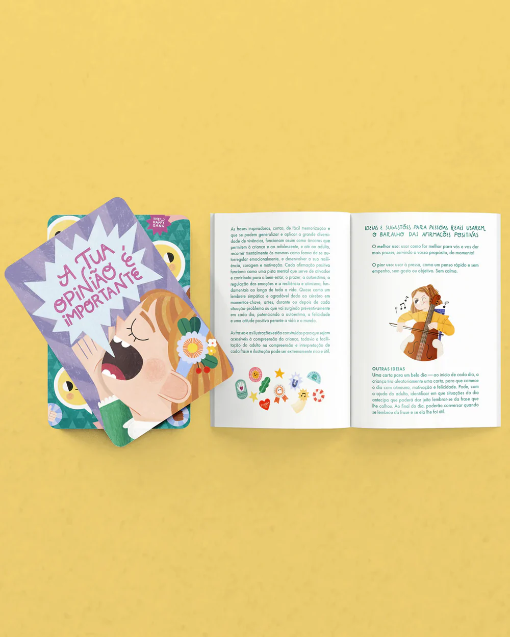 Cartas ilustradas e livreto aberto com texto em português em fundo amarelo