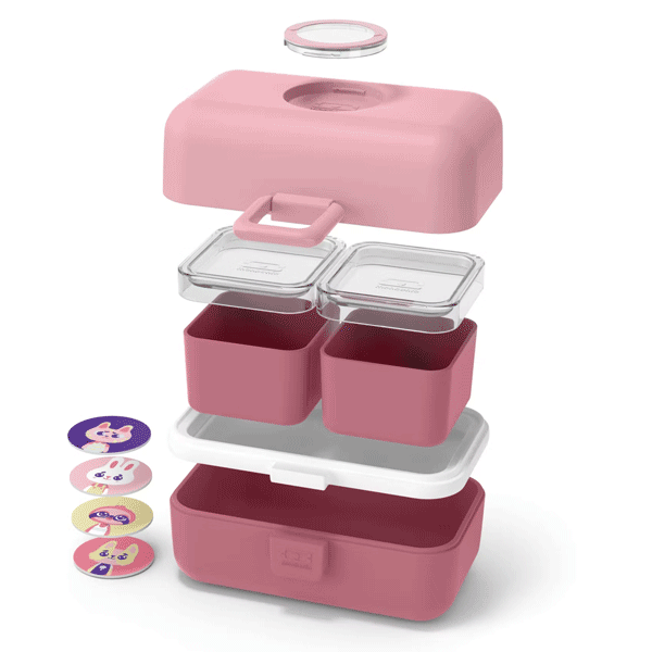 Marmita rosa desmontada com vários compartimentos e discos coloridos ao lado