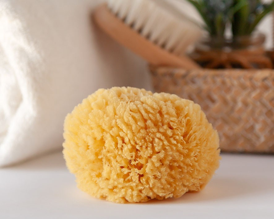 Esponja natural amarela para banho com textura porosa