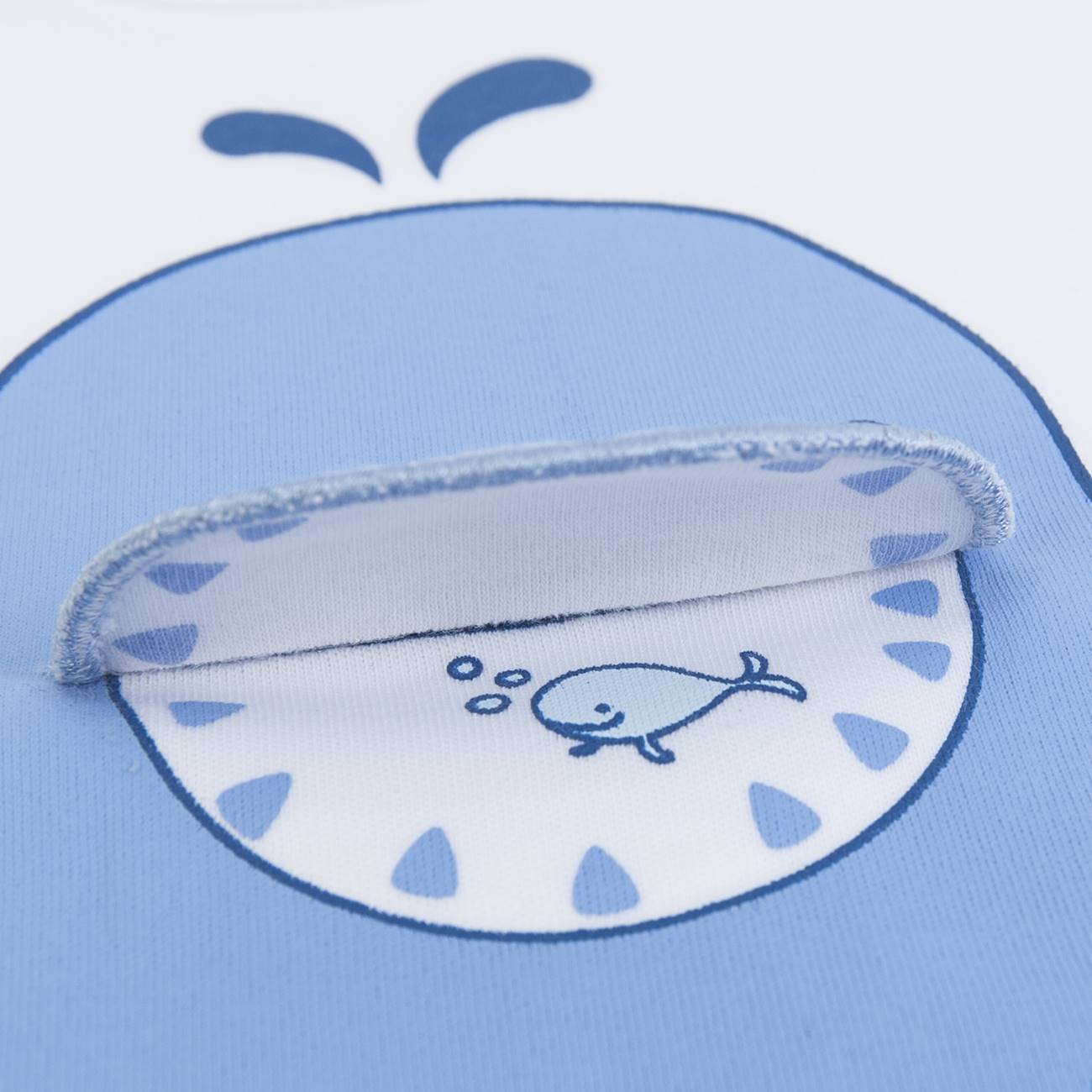Peça de roupa infantil branca e azul com desenho de baleia e bolso