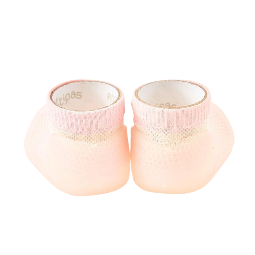 Meias cor-de-rosa com sola antiderrapante e punho elástico.