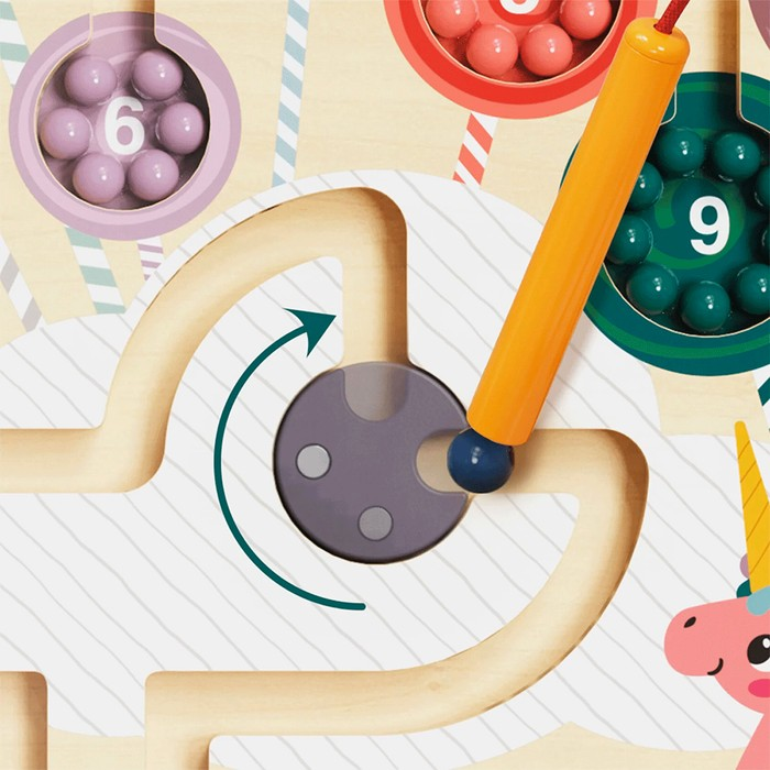 Jogo de madeira com varinha magnética e bolas coloridas numeradas num tabuleiro branco com desenho de unicórnio