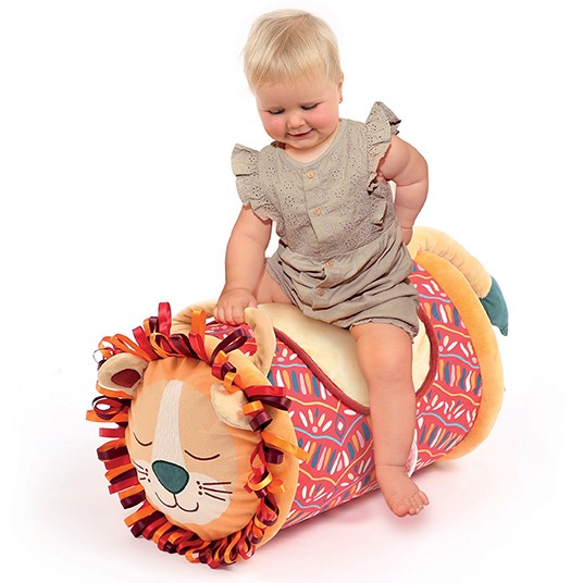 Bebé sentado em brinquedo almofada leão colorido