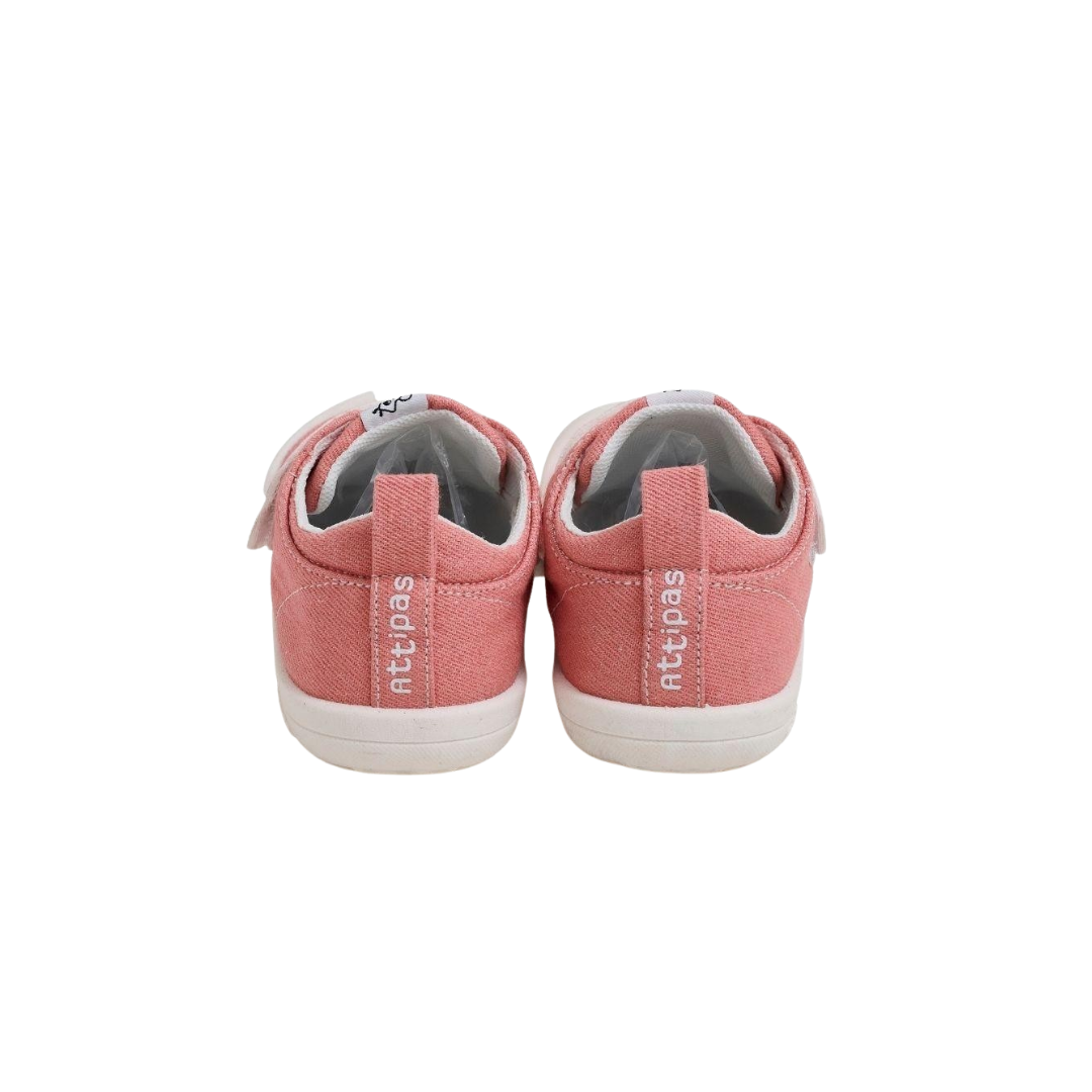 Tênis cor-de-rosa de criança vistos de trás com etiquetas 