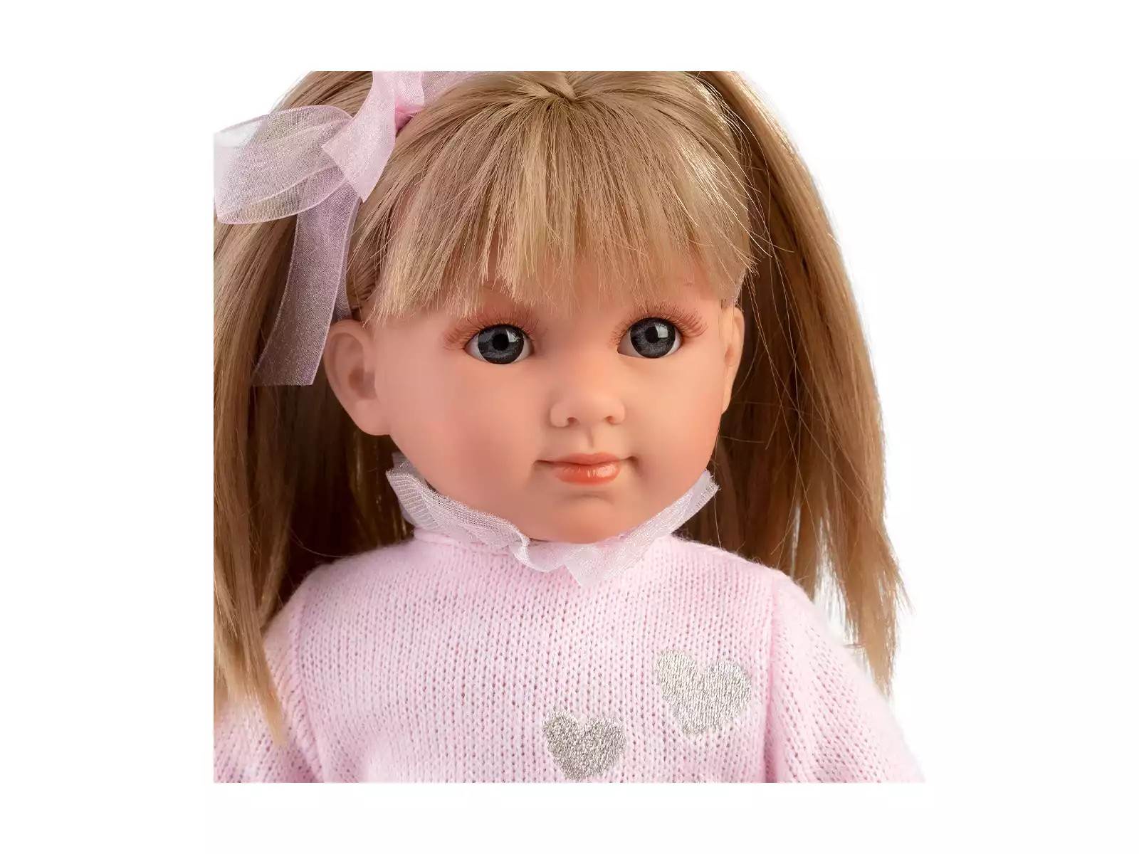 Boneca com camisola rosa clara e cabelo com laços cor-de-rosa