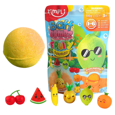 Bomba de banho amarela com figuras de frutas sorridentes e embalagem colorida.