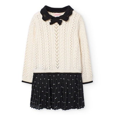 Vestido de criança creme e preto com padrão torcido e corações brancos.