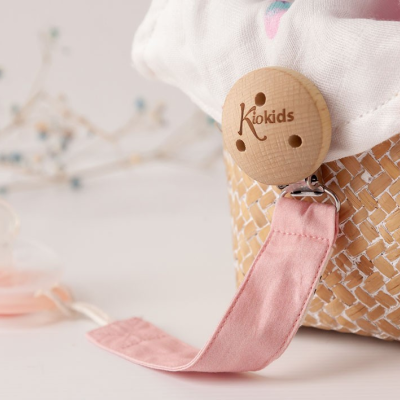 Prendedor de chupeta com botão de madeira 'Kiokids' junto a cesta trançada