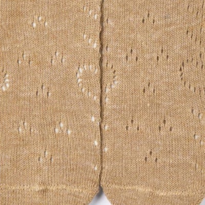 tecido de malha bege com padrão de pequenos furos decorativos em dois painéis simétricos